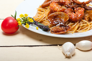 Image showing Italian seafood spaghetti pasta on red tomato sauce 