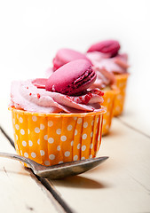 Image showing pink berry cream cupcake with macaroon on top