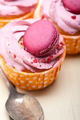 Image showing pink berry cream cupcake with macaroon on top