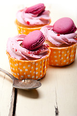 Image showing pink berry cream cupcake with macaroon on top