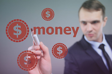 Image showing Businessman writing  Money with marker on transparent wipe board. dollar sign