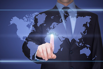 Image showing business, technology, internet and networking concept - businessman pressing button with contact on virtual screens. World map