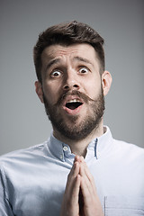 Image showing Man is looking imploring over gray background