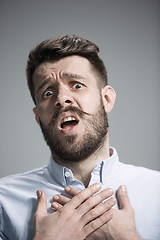 Image showing Man is looking imploring over gray background