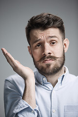 Image showing Man is looking bored. Over gray background