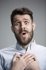 Image showing Man is looking imploring over gray background