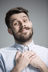 Image showing Man is looking imploring over gray background