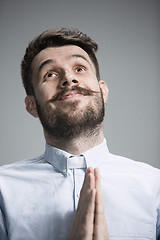 Image showing Man is looking imploring over gray background