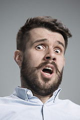 Image showing Man is looking scared. Over gray background
