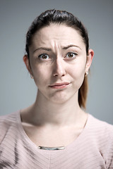 Image showing Woman is looking imploring over gray background