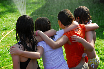 Image showing Group of girls and sprinkler