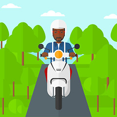 Image showing Man riding scooter.