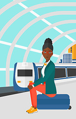 Image showing Woman sitting on railway platform.