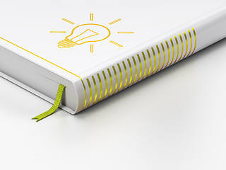 Image showing Finance concept: closed book, Light Bulb on white background