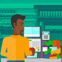 Image showing Cashier at supermarket checkout.