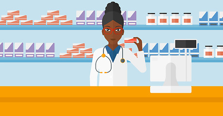 Image showing Pharmacist showing some medicine.