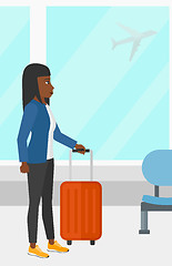 Image showing Woman at airport with suitcase.