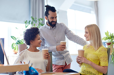 Image showing happy creative team drinking coffee in office