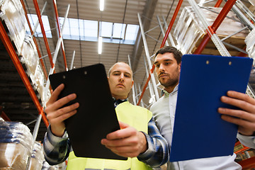 Image showing worker and businessmen with clipboard at warehouse