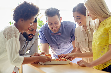 Image showing happy business team eating pizza in office