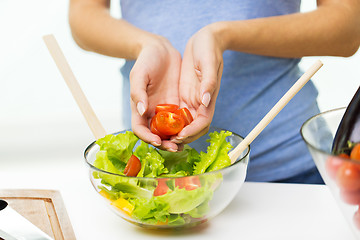 Image showing close up of woman cooking vegetable salad at home