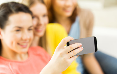 Image showing close up of friends taking selfie with smartphone