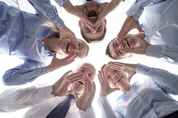 Image showing smiling group of businesspeople standing in circle