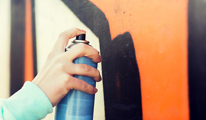 Image showing close up of hand drawing graffiti with spray paint