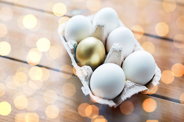 Image showing close up of white and gold eggs in egg box