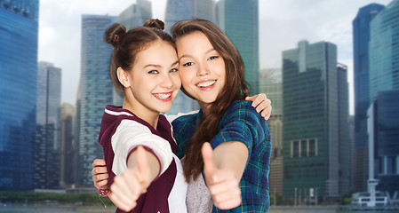 Image showing happy smiling teenage girls showing thumbs up