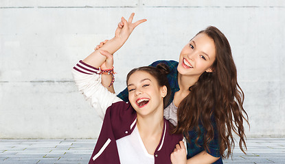 Image showing happy pretty teenage girls showing peace hand sign