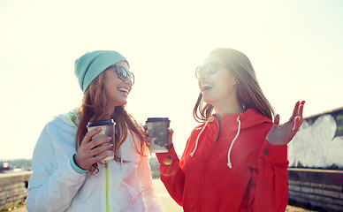 Image showing happy teenage girls with coffee cups on street