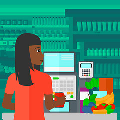 Image showing Cashier at supermarket checkout.