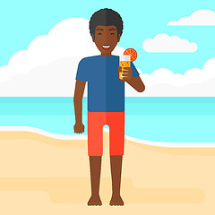 Image showing Tourist with cocktail on the beach.
