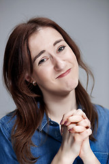 Image showing Woman is looking imploring over gray background