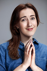 Image showing Woman is looking imploring over gray background