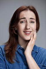 Image showing Woman is looking imploring over gray background