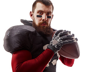 Image showing American football player posing with ball on white background