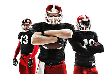 Image showing The three american football players posing with ball on white background