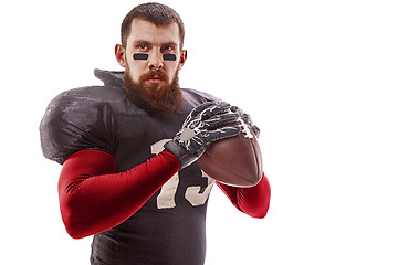 Image showing American football player posing with ball on white background