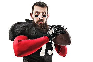 Image showing American football player posing with ball on white background