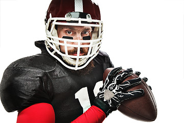 Image showing American football player posing with ball on white background