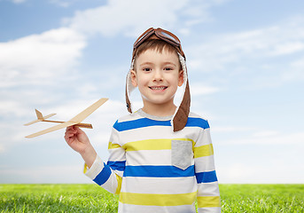 Image showing happy little boy in aviator hat with airplane