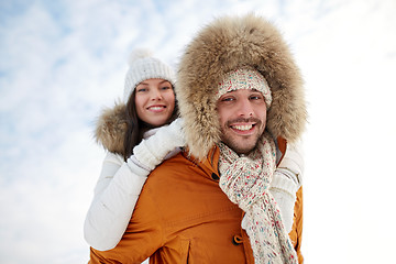 Image showing happy couple having fun over winter background