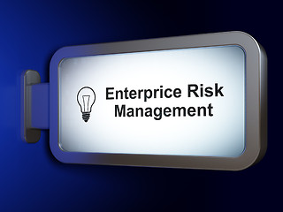 Image showing Finance concept: Enterprice Risk Management and Light Bulb on billboard background