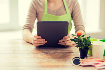 Image showing close up of woman or gardener holding tablet pc