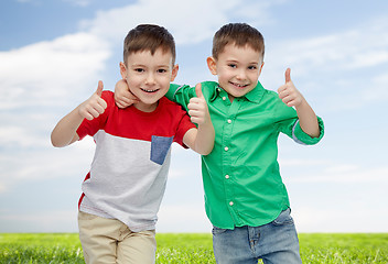 Image showing happy smiling little boys showing thumbs up