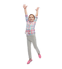 Image showing happy little girl jumping in air