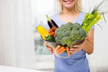 Image showing close up of woman holding vegetables in bowl