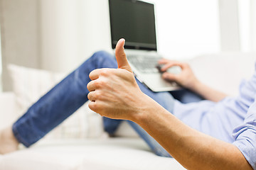 Image showing close up of man typing on laptop at home